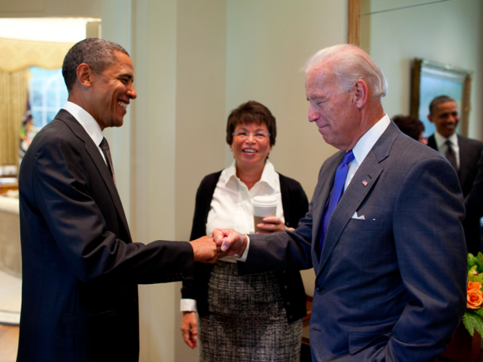 Obama fist-bumps Biden, as Senior Advisor Valerie Jarrett looks on, before a meeting in the Oval Office on Sept. 16, 2010.