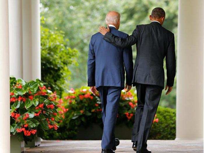 Obama and Biden walk back to the Oval Office after speaking about the Supreme Court ruling to uphold the nationwide availability of tax subsidies under Obamacare.