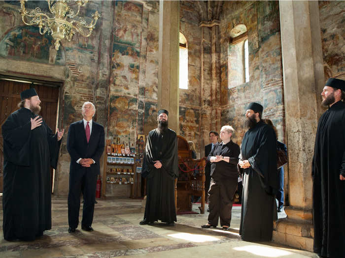 Here, he tours the Decani Monastery with Serbian Orthodox Monk Father Sava in Decani, Kosovo, on May 21, 2009.