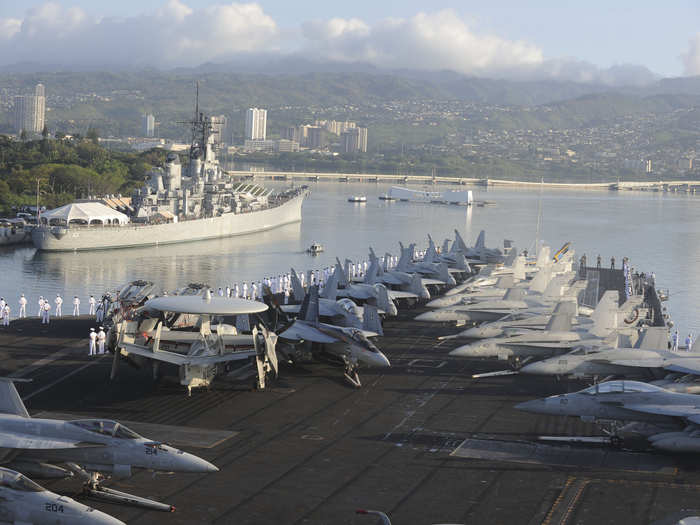 Sailors man the rails as the aircraft carrier USS Nimitz (CVN 68) enters Pearl Harbor.