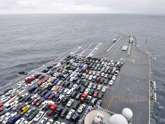 The aircraft carrier USS Ronald Reagan transports Sailors’ vehicles.