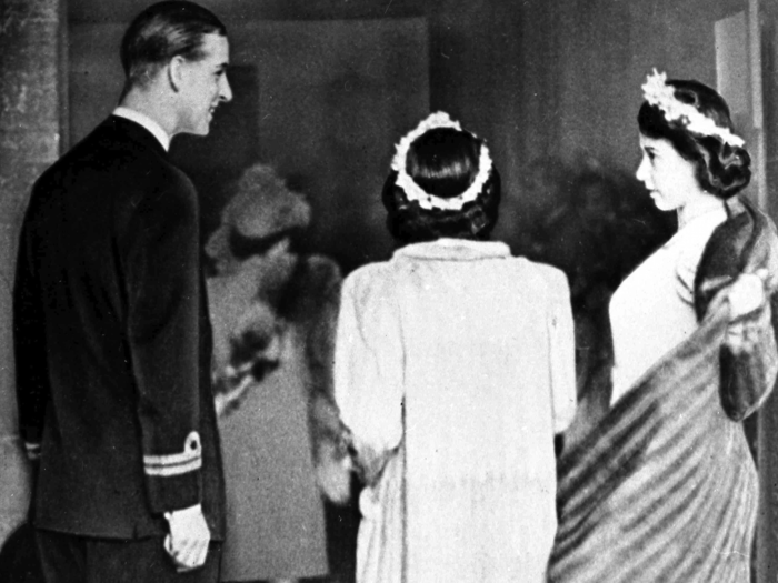 1946: Prince Philip of Greece acted as an usher, assisting Princess Elizabeth with her coast as they arrive at Romsey Abbey, for the wedding of Patricia Mountbatten. A year later, they themselves would walk down the aisle.