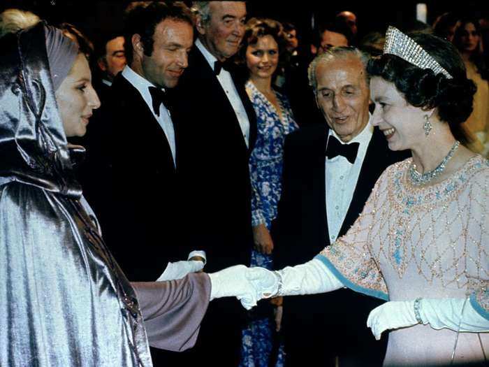 1975: Film and music icon, Barbara Streisand, shakes hands with the monarch in London in 1975 at the Royal Film performance. After the presentations, the Queen saw the musical "Funny Lady," in which Streisand is the star.