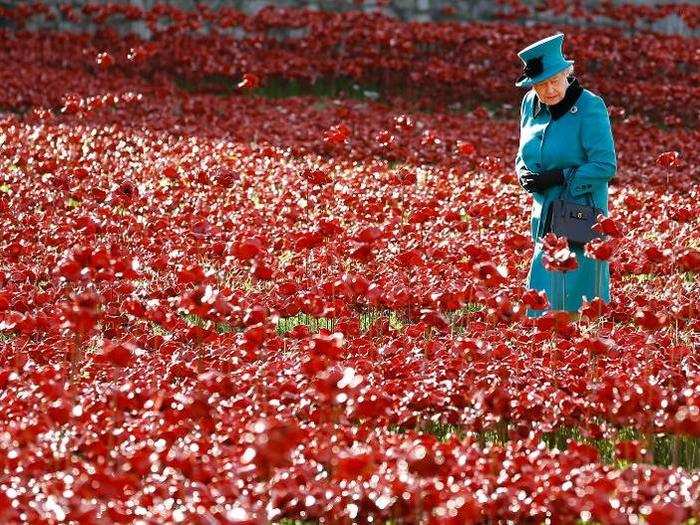 2014: Here, the queen walks through a field of ceramic poppies at The Tower of London in October 2014. The poppies were part of a ceramic poppy installation called "Blood Swept Lands and Seas of Red," which marked the centenary of the outbreak of World War I. There were 888,246 poppies in total, each one representing a British military fatality during the war.