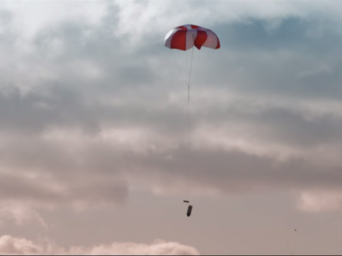 After the drone is captured in the net, a parachute brings it down to earth without breaking the drone.