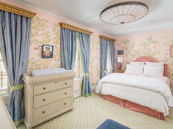 A princess-style bedroom has fanciful blue drapes and painted walls.