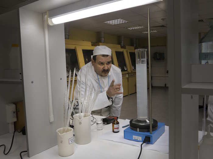 Here, a laboratory worker performs radiation level checks on samples from the fourth unit.