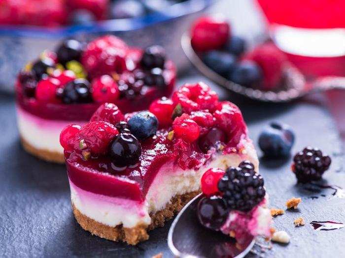 The origins of cheesecake are hotly debated. The now widely-popular English version is made with a base of crushed, buttered biscuits, a filling of cream cheese, sugar, and cream, and fruit jelly top.