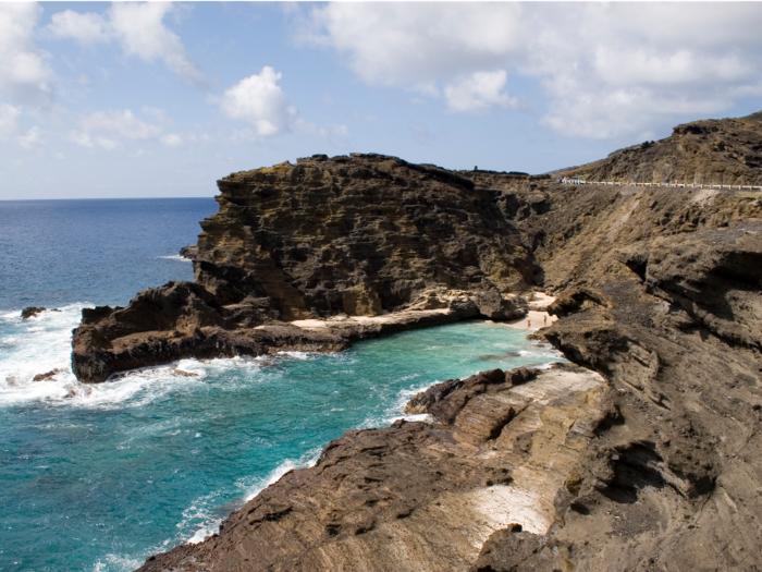 Halona Beach Cove sits tucked between Halona Point and the Halona Blowhole in Oahu, Hawaii. Made popular in the movie “From Here to Eternity”, the beach here was nicknamed Eternity Beach and is accessed by hiking down the surrounding rocks. Explore the little private haven hidden from the main road, but avoid swimming here during strong currents as it can be dangerous.