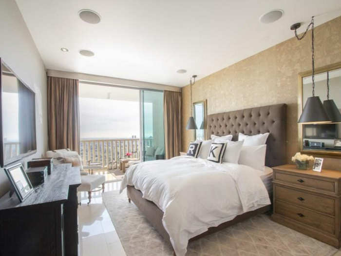 The bedrooms have large windows and boast neutral color palettes.