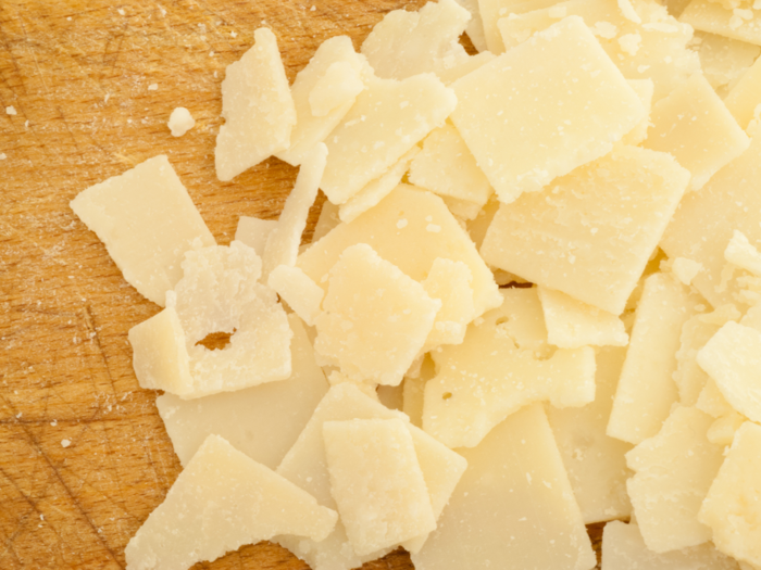 Parmesan is lovingly known as the "King of Cheeses" because it goes well on anything from pasta to pizza to soup to salad. The American version is very similar to Italian Parmigiano-Reggiano, but it is legally labeled "Parmesan" when produced in the US.