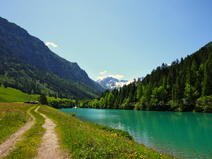 Liechtenstein, which sits between Switzerland and Austria, is one of the richest and smallest countries in the world. Its setting resembles something out of a fairy tale, with rising peaks, lush hillsides, and ancient castles. It