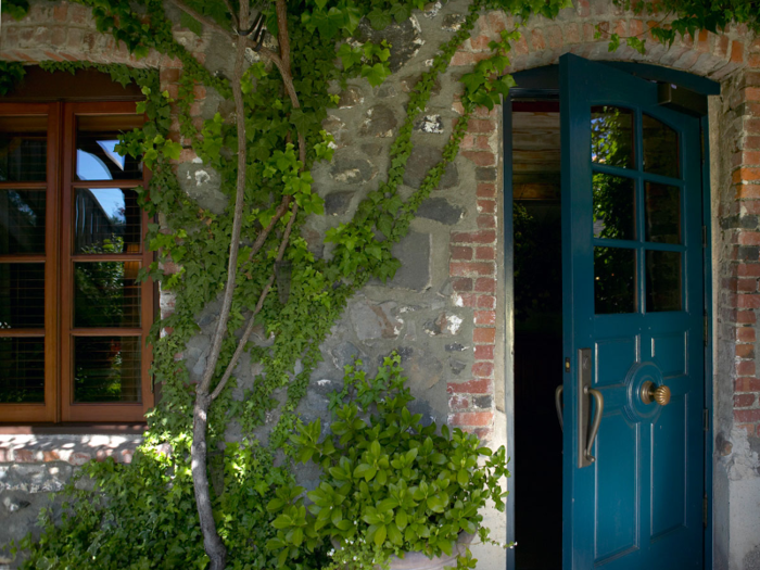 It is surrounded by gardens and greenery and has a quaint courtyard for diners. Guests enter the restaurant through this blue door.