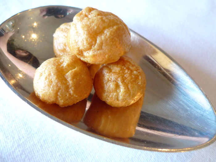 While dishes change on a regular basis, guests can always expect a plate of gougères, a savory French pastry with a cheesy inside.