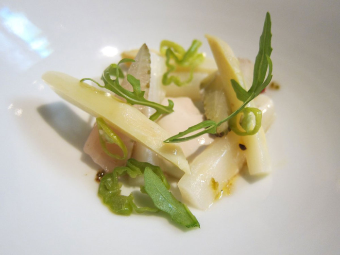 Dishes will also typically include a salad with ingredients from the garden. The type of salad will vary based on what is in season. Pictured here is a salad with poached white asparagus and peppers.