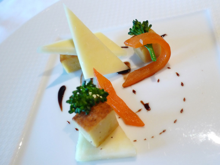 This cheese plate incorporates broccolini, sweet peppers, panisse, 100-year-aged balsamic vinegar, and olive oil.