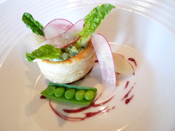 This dish includes romaine lettuce, sugar snap peas, fennel bulb, radishes, and a port wine reduction served in a delicious golden puff pasty.