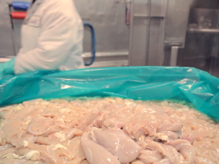 The cart of chicken breast meat travels across the factory to the "blending room."