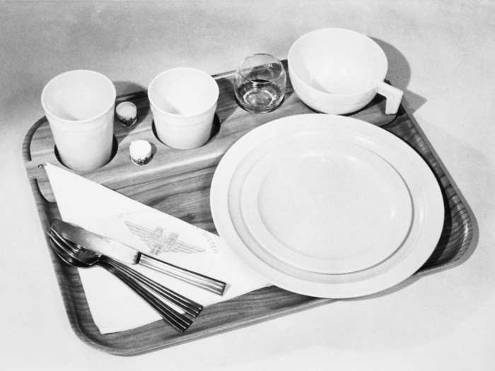 Dinner trays looked very different in the 1960s, when they included real plates, a glass, and metal cutlery.