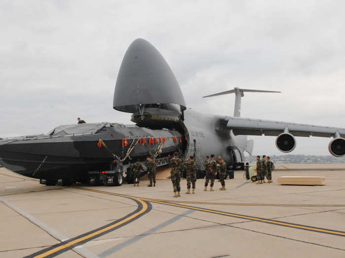 Here the C-5 unloads an 81 foot boat for the Navy.