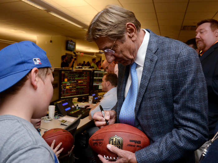 Former football quarterback Joe Namath signed a football.