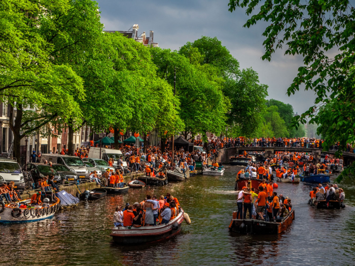 The streets of Amsterdam are filled with orange during Koninginnedag, also known as Queen