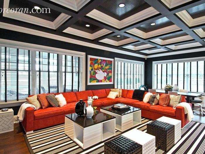 The family room is modern and eye-catching, with a coffered ceiling.