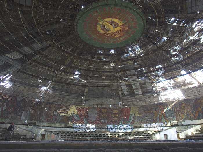 On the inside the cathedral-like building has been abandoned, the roof is falling in, and the walls are covered in graffiti.