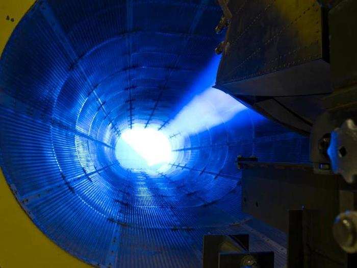 An F-22 Raptor jet engine is tested in a full afterburner state. Airmen test aircraft engines like these in a specialized hangar, known as a "hush house", to ensure that all components are functioning properly.