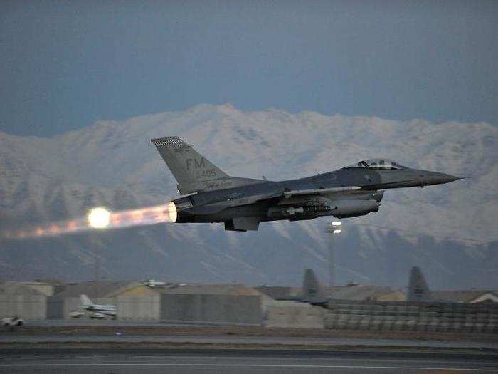 A US Air Force F-16 Fighting Falcon takes off on a mission at dawn from Bagram Airfield, Afghanistan.