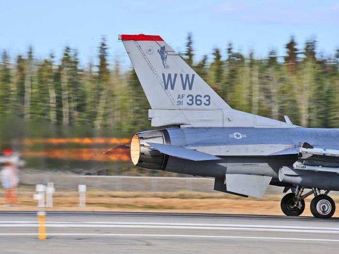 A US Air Force F-16 Fighting Falcon aircraft assigned to the 13th Fighter Squadron, Misawa Air Base, Japan, uses its afterburner to launch down the runway.