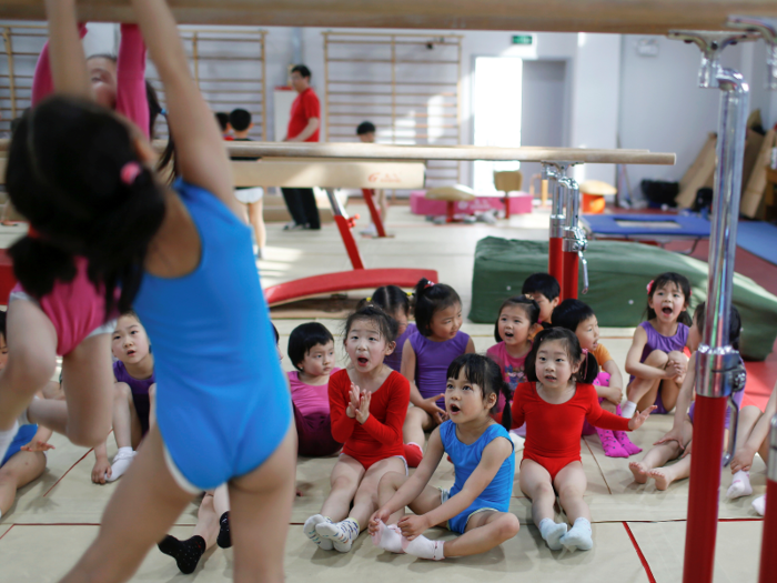 The Shanghai Yangpu Youth Amateur Athletic School is trying to recruit new students by visiting kindergartens and reframing gymnastics as a fun, after-school activity to parents. "We call it happy gymnastics," said principal Zhu Zengxiang.