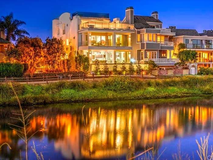 The two-story, six-bedroom house sits right on a canal, and has views of the ocean.