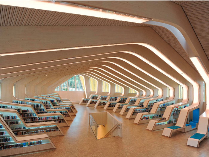 At the Vennesla Library and Cultural Centre, a system of rib-shaped beams and columns create eye-catching bookshelves. It