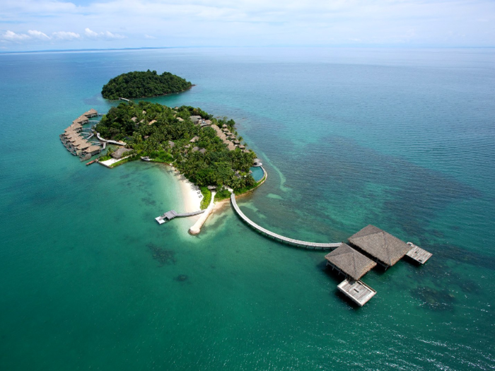 Song Saa Private Island spans both the islands of Koh Ouen and Koh Bong in Cambodia. The two islands are connected via a footbridge that sits above a marine reserve, and accommodations include over-the-water villas with jungle and ocean views. Instead of traditional spas, guests will find various treatment villas nestled in the rainforest and around the islands.