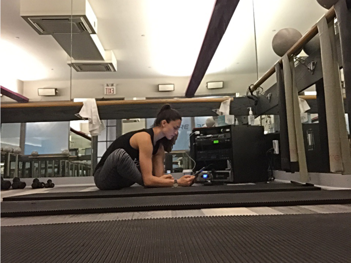 Before class, Kara stretched out in the FlyBarre studio and did a sound check, to make sure that everything was in order. A big component of FlyBarre is music —each instructor makes their own playlist, and every exercise is aligned with and synced to a song.