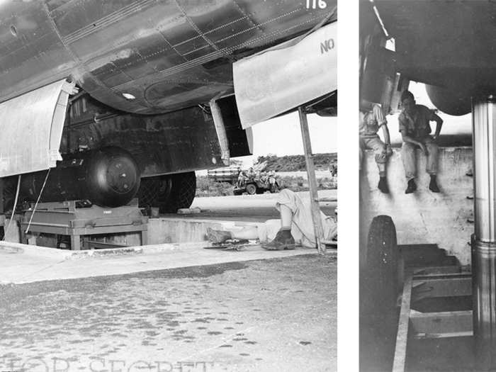 Using the hydraulic lift, "Little Boy" is carefully raised and loaded into the belly of the Enola Gay.