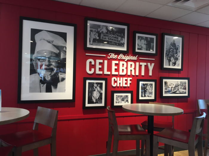 The Colonel is everywhere at the remodeled location — especially the back wall, covered in photos of Sanders. Variations on the Sanders-themed red wall will be a included in each remodeled location.