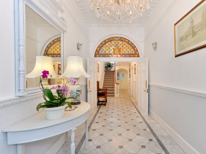 The hall retains its original features like a stained glass fanlight screen ceiling mouldings and marble flooring. This picture gives an idea of how far back the house extends.