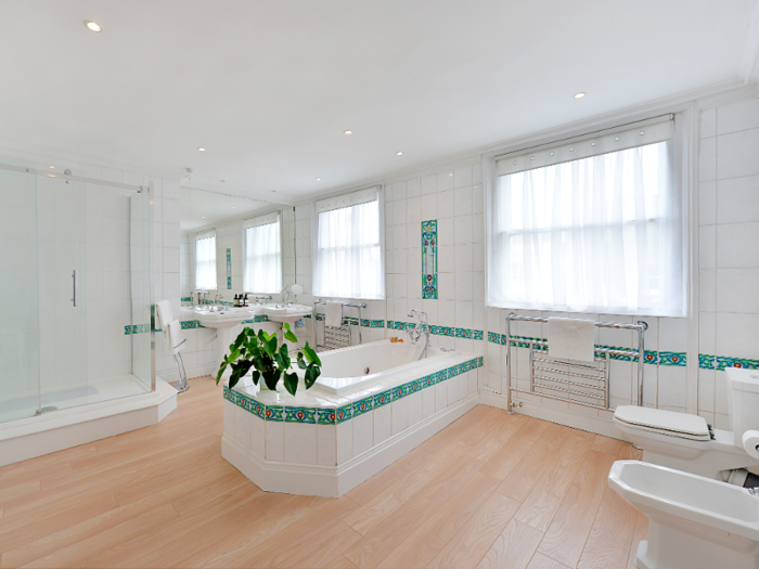 The bathroom has "his and her" sinks, along with a separate walk-in shower and bath.