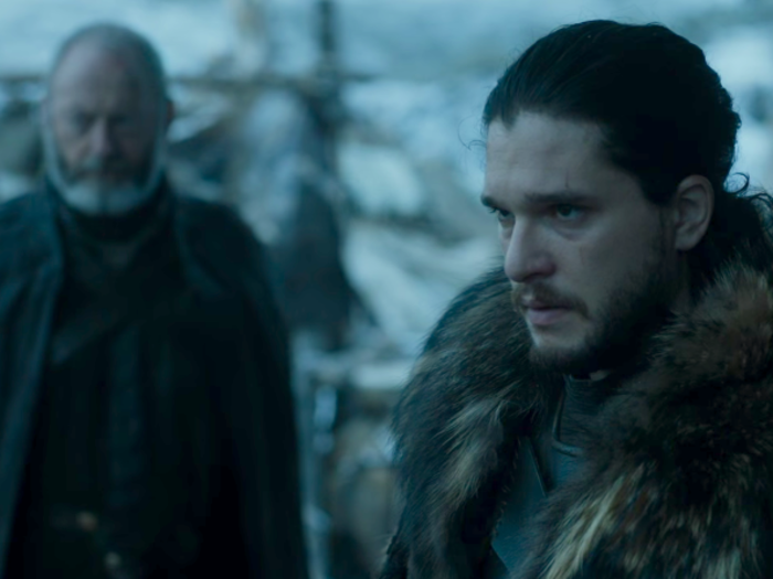 Jon looks grim as he faces the wildlings in their camp.