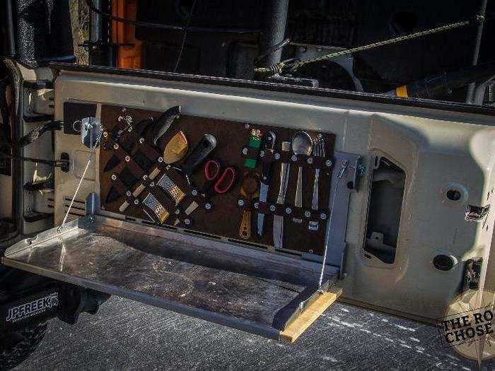 I bought a tailgate table with built-in cutting board, and then made a cutlery holder/organizer so all my most-often used stuff is easy to get at.