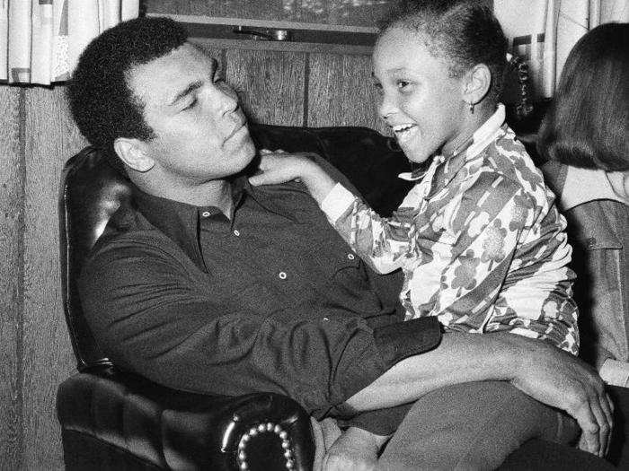 A fighter and a family man: Muhammad Ali cuddles up to his seven-year-old daughter Maryum Ali, August 15, 1975.