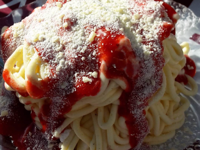 Spaghettieis is a novel ice cream sundae created by German chef Dario Fontanella. He presses vanilla ice cream through a potato ricer to create "noodles," then tops it with strawberry glaze and coconut or white chocolate shavings to mimic tomato sauce and Parmesan cheese. Taste the original at Dario Fontanella