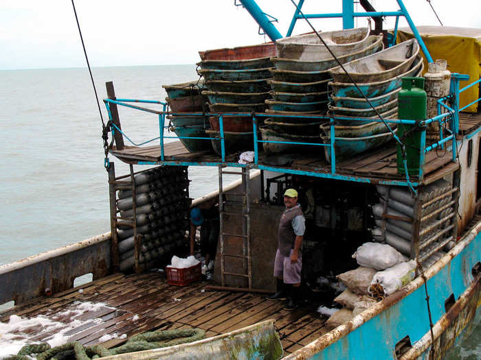 Ice and other supplies are loaded onto the boats for the two-week journey out to sea. This boat will house between 40 and 50 men.