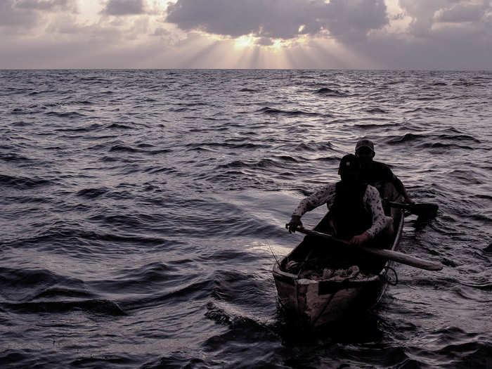 Dinner is just about ready as the last canoe is pulled into the boat. Each day ends as the sun sets.