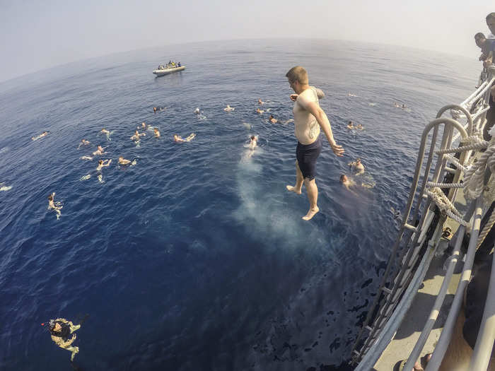 A sailor from the USS Antietam joins his fellow crew in the Indian Ocean.