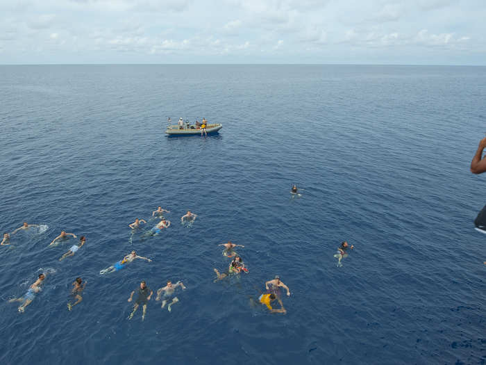 Sailors from US 7th Fleet flagship USS Blue Ridge participate in a swim call after a Crossing the Line ceremony.