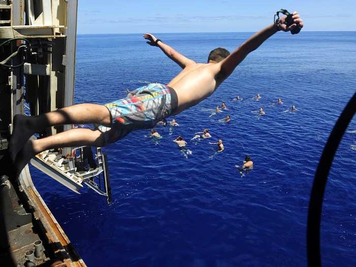 Sailors and Marines from the USS Mesa Verde swim in the Mediterranean Sea.