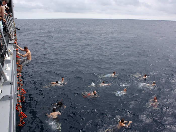 Sailors aboard the USS Thach participate in a swim call during the Crossing the Line ceremony weekend, which commemorates a sailor